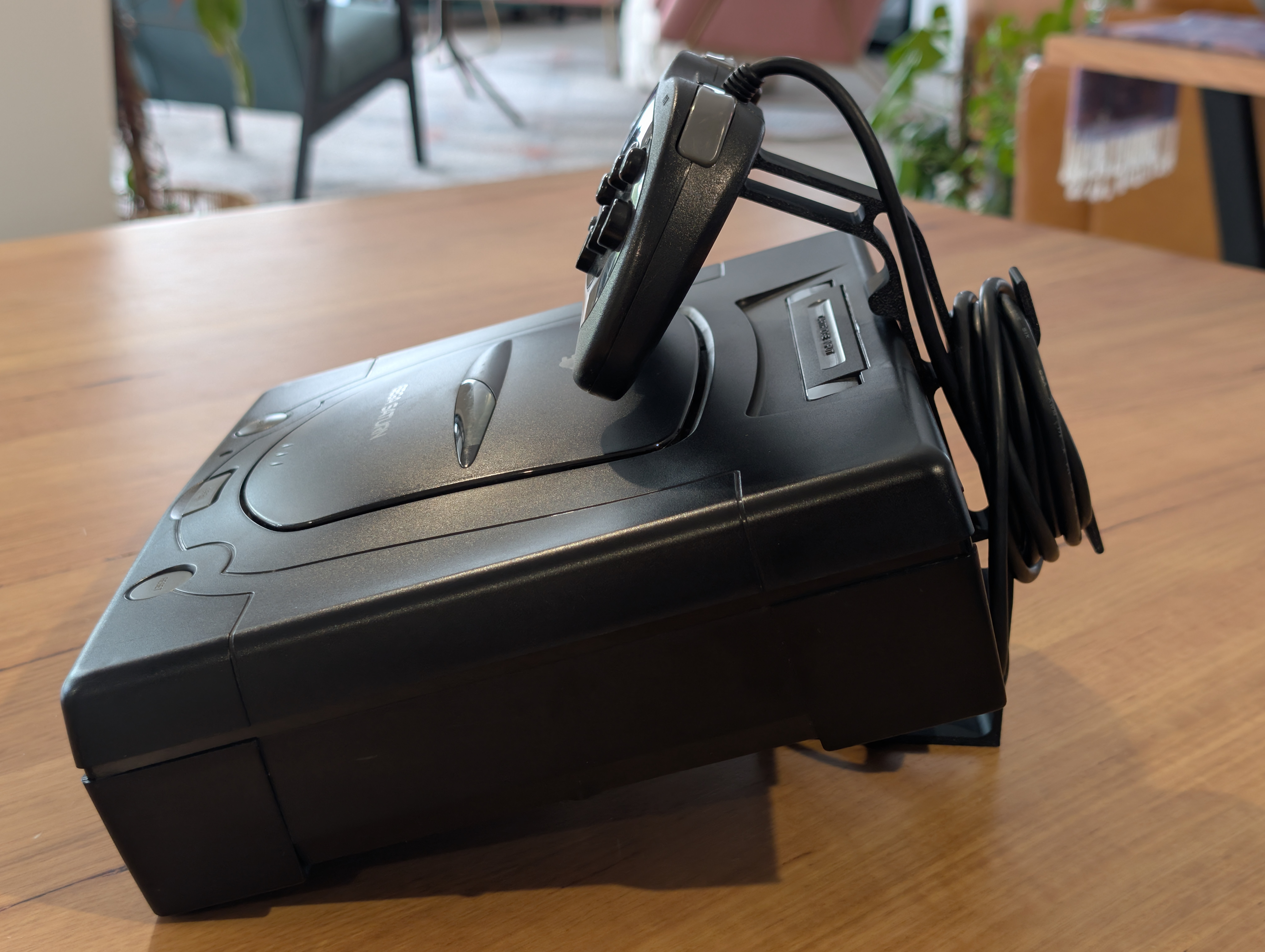 Sega Saturn på ställ från sidan – lutande displaylage